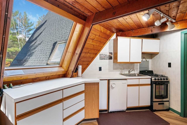 kitchen featuring dishwasher, white cabinetry, and gas range