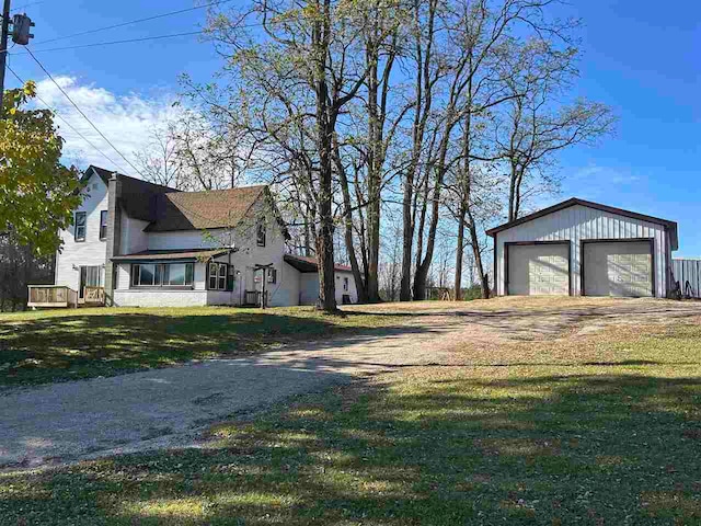 view of property exterior with an outdoor structure, a garage, and a lawn