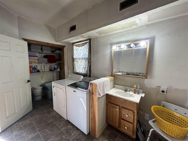 5157 Graham Rd, East Jordan, MI 49727 - clothes washing area featuring separate washer and dryer, laundry area, visible vents, and a sink