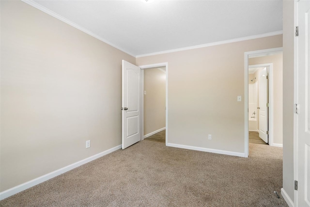 empty room with crown molding and light colored carpet