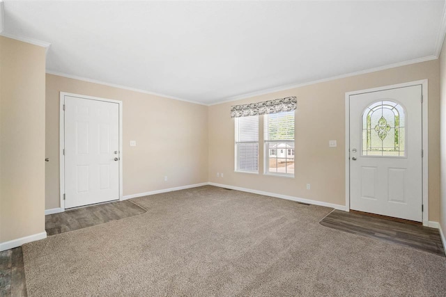 entrance foyer with crown molding and dark colored carpet