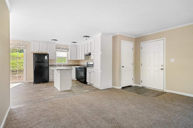 kitchen with black appliances, a kitchen island, white cabinets, crown molding, and light colored carpet