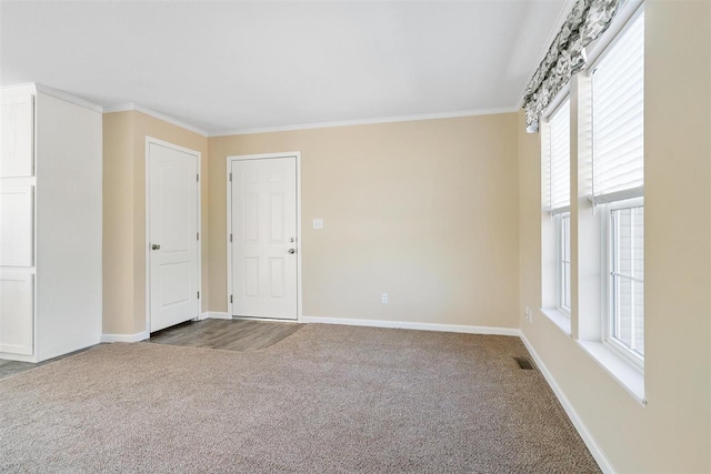 unfurnished room featuring crown molding, carpet floors, and plenty of natural light