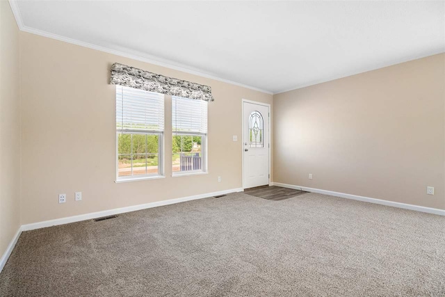 carpeted spare room featuring ornamental molding