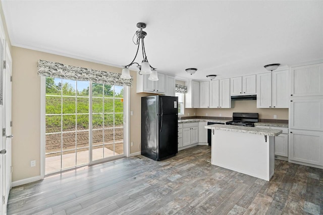 kitchen featuring white cabinetry, wood-type flooring, black appliances, pendant lighting, and a center island