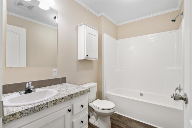 full bathroom with toilet, wood-type flooring, shower / washtub combination, ornamental molding, and vanity