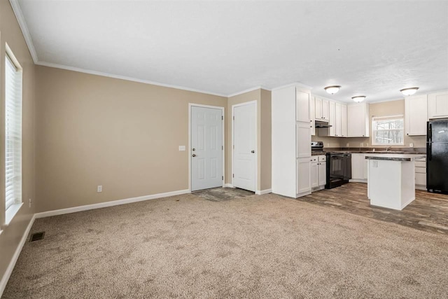 kitchen with carpet, crown molding, white cabinetry, baseboards, and black appliances