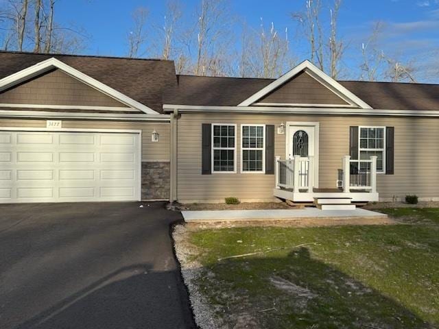 3911 Leslie Ln, Petoskey, MI 49770 - view of front of home with a front lawn, driveway, and a garage