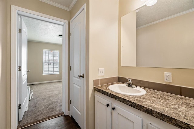 3911 Leslie Ln, Petoskey, MI 49770 - bathroom featuring crown molding, a textured ceiling, baseboards, and vanity