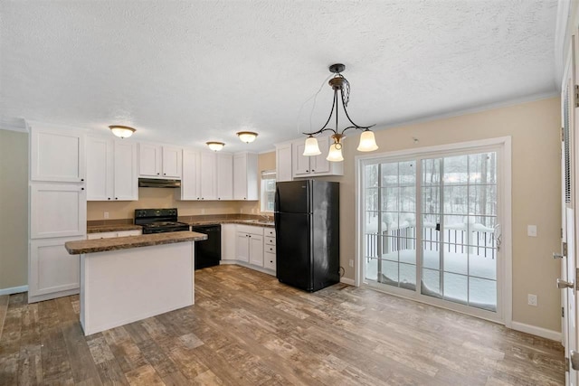 3911 Leslie Ln, Petoskey, MI 49770 - kitchen with white cabinets, a kitchen island, wood finished floors, and black appliances