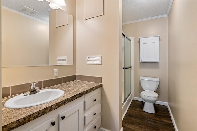 3911 Leslie Ln, Petoskey, MI 49770 - full bath with toilet, wood finished floors, a shower stall, and ornamental molding