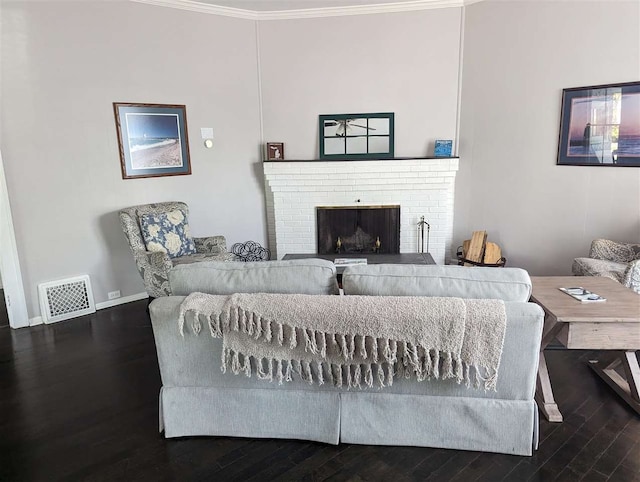 living room with a fireplace, dark wood-type flooring, and crown molding