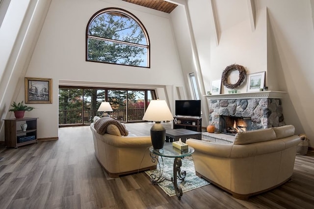 living room with a fireplace, beamed ceiling, high vaulted ceiling, and hardwood / wood-style floors