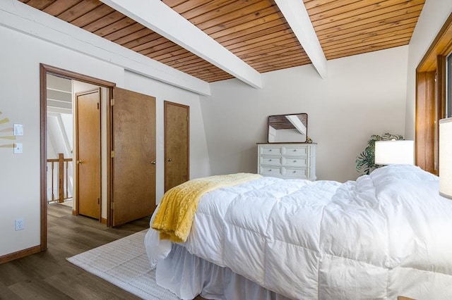 bedroom with dark hardwood / wood-style floors, beam ceiling, and wooden ceiling