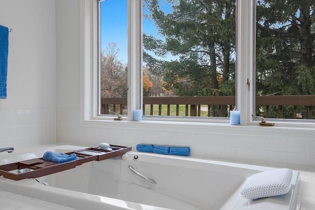 bathroom with tiled bath and tile patterned flooring