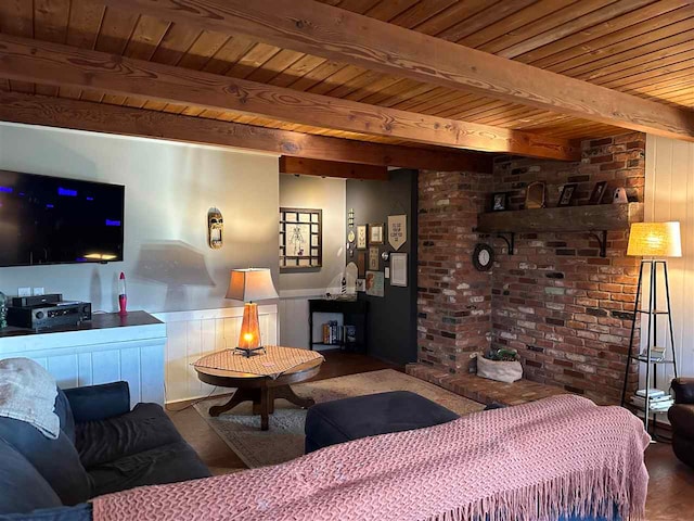 living room with beamed ceiling, wood ceiling, and hardwood / wood-style flooring