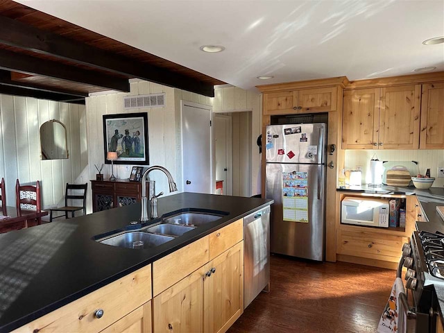 kitchen with dark wood-type flooring, sink, beamed ceiling, light brown cabinets, and appliances with stainless steel finishes