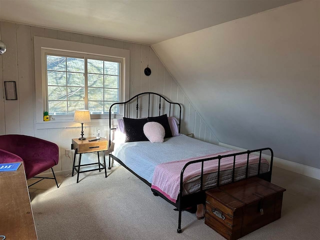 carpeted bedroom with vaulted ceiling