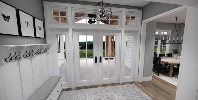 mudroom featuring wood-type flooring, a notable chandelier, and french doors