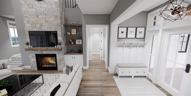 mudroom with a fireplace and hardwood / wood-style flooring