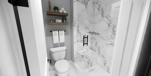 bathroom featuring toilet and a tile shower