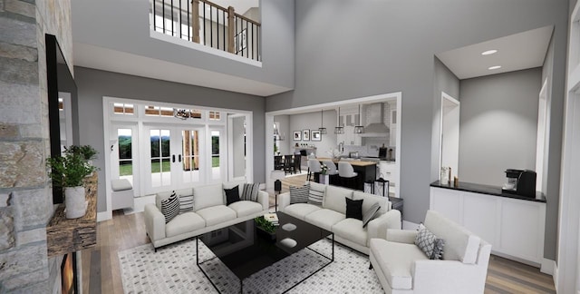 living room with hardwood / wood-style flooring, a towering ceiling, an inviting chandelier, and french doors