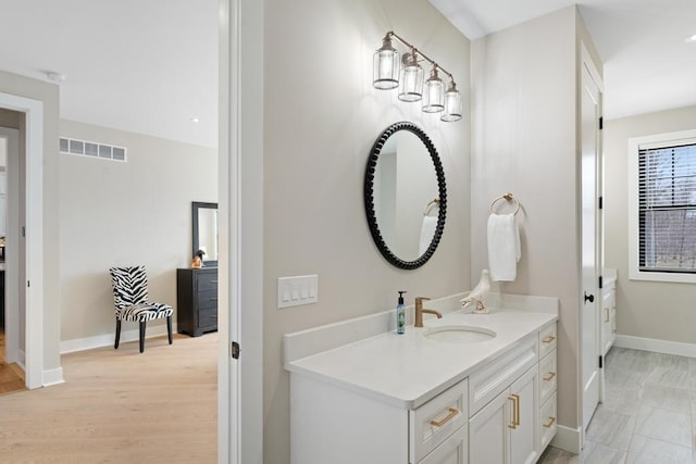 bathroom with hardwood / wood-style floors and vanity