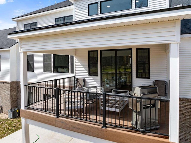 deck featuring central AC unit and grilling area