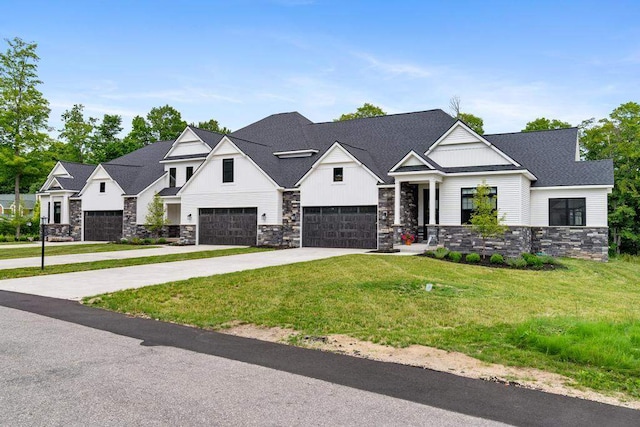 view of front of house with a front yard and a garage