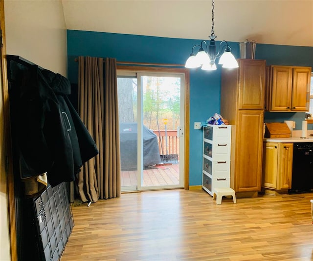 interior space with pendant lighting, dishwasher, light wood-type flooring, and a notable chandelier