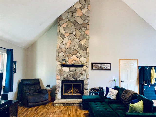 living room with a fireplace, hardwood / wood-style floors, and vaulted ceiling