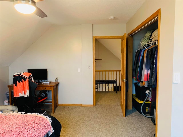 bedroom with ceiling fan, a closet, light colored carpet, and lofted ceiling