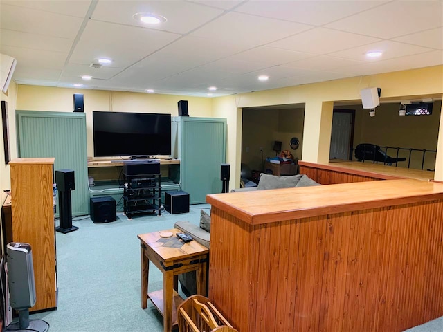 interior space with a paneled ceiling and light carpet