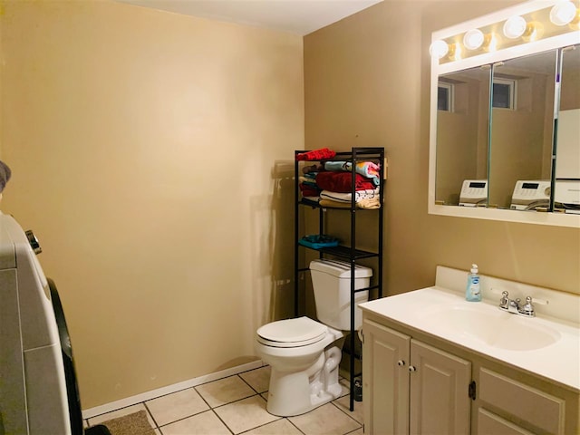 bathroom with tile patterned floors, vanity, toilet, and washer / clothes dryer