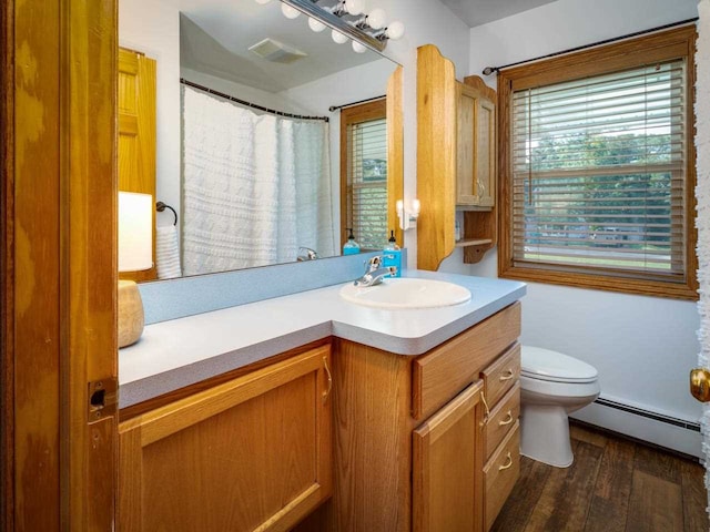 bathroom featuring toilet, vanity, a baseboard radiator, and wood-type flooring