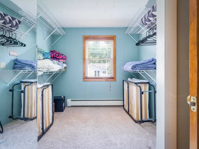 interior space with carpet floors and a baseboard heating unit