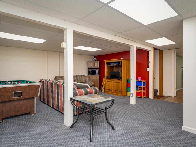 game room featuring dark colored carpet and a drop ceiling