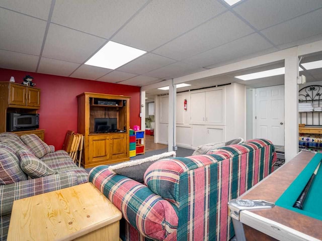 living room featuring a drop ceiling