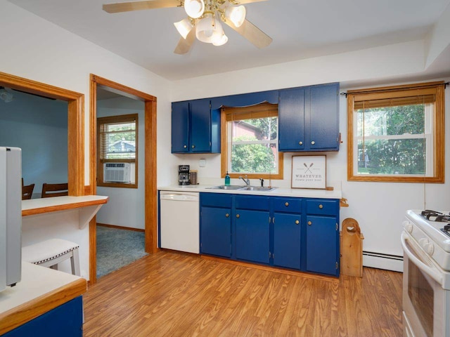 kitchen featuring sink, blue cabinets, a baseboard heating unit, plenty of natural light, and white appliances