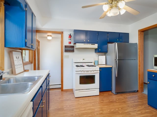 kitchen with stainless steel fridge, gas range gas stove, sink, and blue cabinets