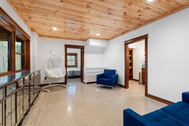 living area featuring a wealth of natural light, radiator heating unit, and wood ceiling