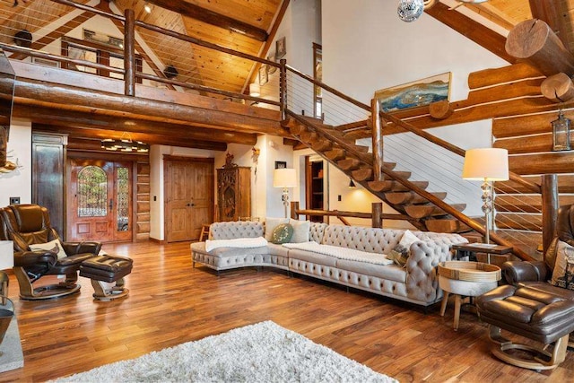 living room with log walls, high vaulted ceiling, beamed ceiling, hardwood / wood-style floors, and wood ceiling