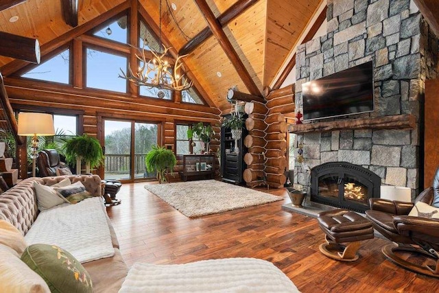 living room featuring high vaulted ceiling, a stone fireplace, hardwood / wood-style flooring, beam ceiling, and wood ceiling