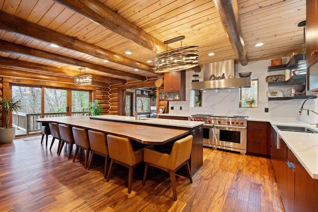 kitchen with backsplash, light hardwood / wood-style floors, double oven range, and wooden ceiling