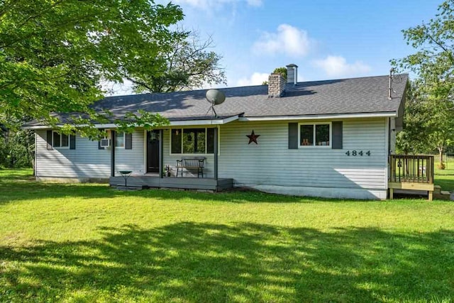 back of house with a lawn and a wooden deck