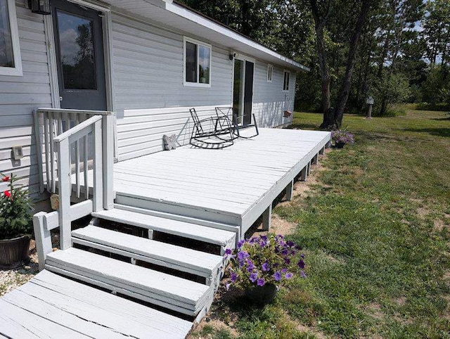 wooden deck with a lawn