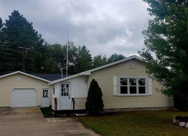 6127 Pells St, Pellston, MI 49769 - view of front of house with an attached garage, concrete driveway, and crawl space