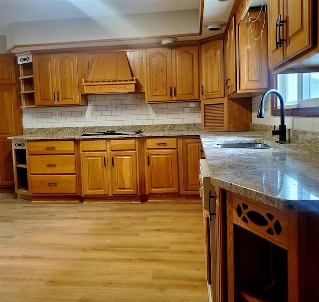 6127 Pells St, Pellston, MI 49769 - kitchen featuring open shelves, custom exhaust hood, a sink, and brown cabinetry