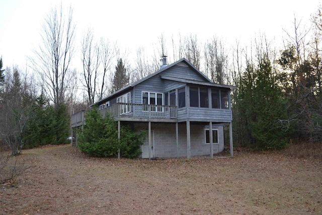 back of property with a sunroom