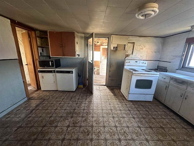 kitchen with white electric range oven and washer and clothes dryer